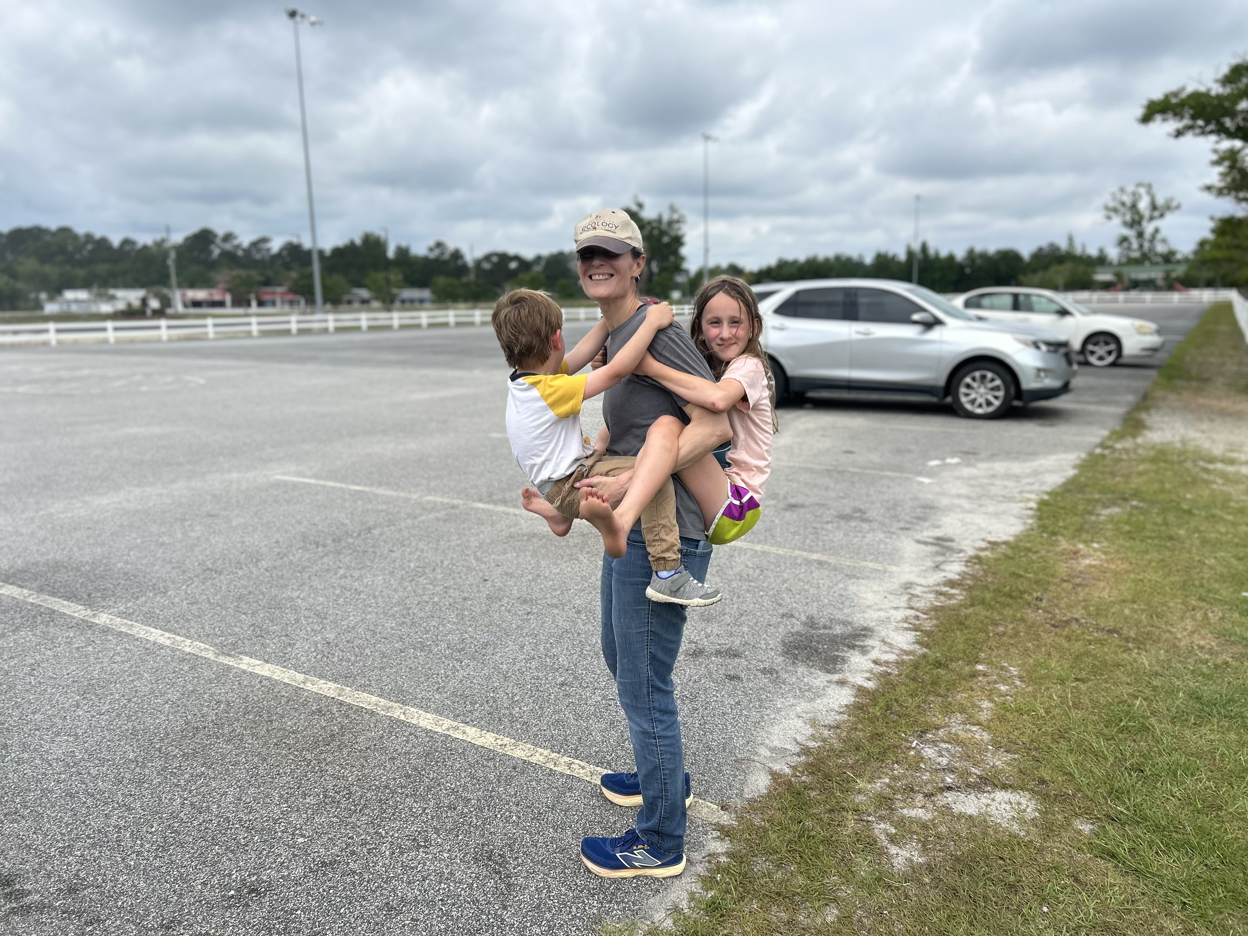 Linden carrying two of her kids — functional fitness in action